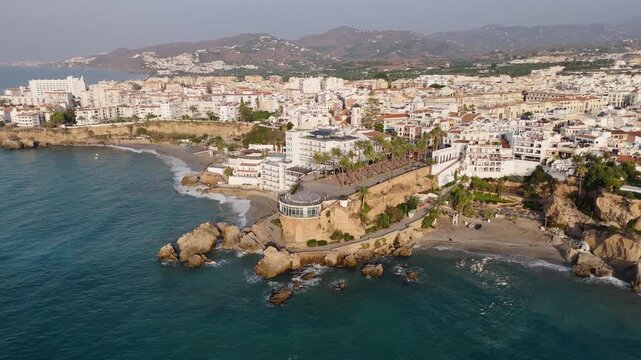 Aerial Drone POV of Nerja coastal town, which is a municipality on the Costa del Sol in the province of Malaga in the autonomous community of Andalusia in southern Spain.