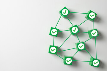 Quality assurance and approved network concept.Connected green blocks with checkmark icon representing validation,success, completed tasks,and system correctness on a white background with copyspace.