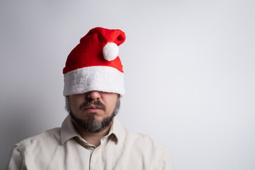 Man with santa hat pulled over eyes