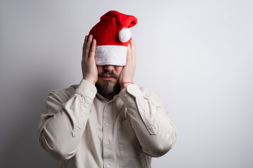 Man with santa hat pulled over eyes