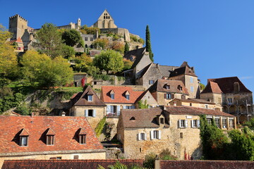 The impressive village Beynac et Cazenac, Dordogne, France, blend into a magnificent cliff, with traditional medieval houses (with sloping slate roofs) and the castle on the top