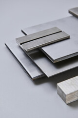 High quality close up image of stainless steel metal bars and flat sections with smooth industrial texture, suitable for construction, engineering, manufacturing, and industrial design concepts.
