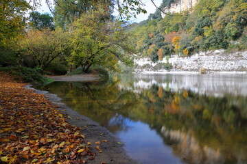 Reflections on the river Dordogne near the village La Roque Gageac, Dordogne, France, with Autumn colors