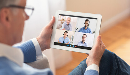 Online call, business video conference, family chat and modern gadgets for remote communication. Senior man looks at tablet with video of adult and young guys in headphones, at home interior, collage