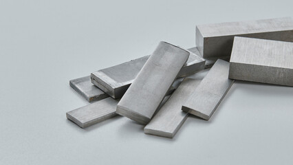 High quality close up image of stainless steel metal bars and flat sections with smooth industrial...