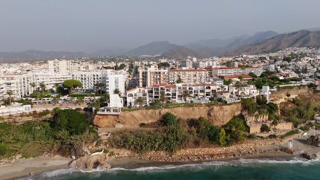 Aerial Drone POV of Nerja coastal town, which is a municipality on the Costa del Sol in the province of Malaga in the autonomous community of Andalusia in southern Spain.