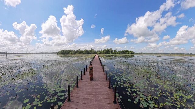 Woman Crossing the Sacred Bridge to Neak Pean in Cambodia