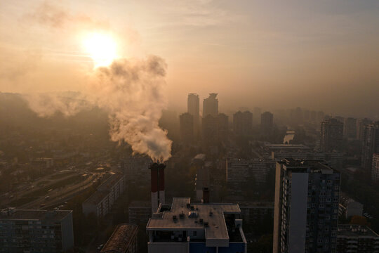 Aerial view of smoke billowing from a chimney amidst the urban sprawl, casting a hazy glow over the city skyline, Sarajevo, Federation of Bosnia and Herzegovina, Bosnia and Herzegovina.