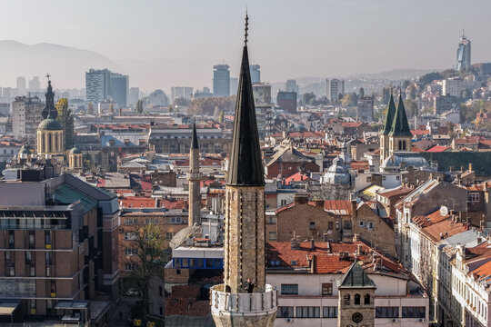 Aerial view of the minaret piercing the skyline amidst a sea of red-tiled roofs, blending the old with the modern cityscape, Sarajevo, Federation of Bosnia and Herzegovina, Bosnia and Herzegovina.