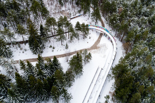 Aerial view of the snow-dusted Olympic bobsleigh track winds through the frosted forest, a ribbon of winter sport history, Sarajevo, Federation of Bosnia and Herzegovina, Bosnia and Herzegovina.