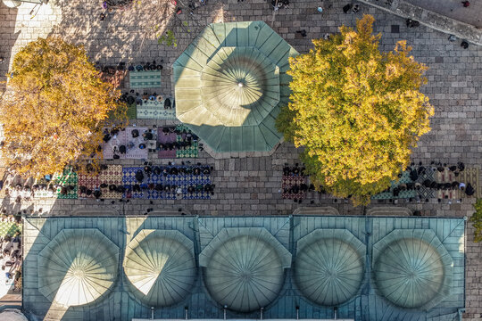 Aerial view of the Gazi Husrev-beg Mosque's domes and courtyard filled with people praying under the autumn trees, Sarajevo, Federation of Bosnia and Herzegovina, Bosnia and Herzegovina.