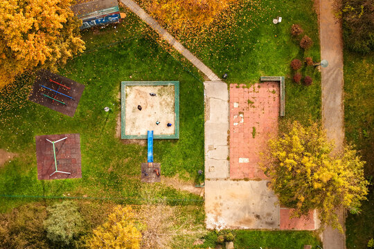 Aerial view of a playground with vibrant autumn foliage casting shadows on the green grass, Sarajevo, Federation of Bosnia and Herzegovina, Bosnia and Herzegovina.
