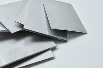 Close up image of metallic surface sheets with brushed and matte finishes, showcasing industrial texture and modern material design for architecture, manufacturing, and product design applications.