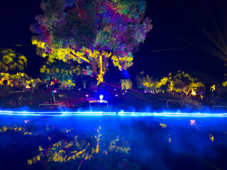 Enchanting Night Scene with Vibrant Lights Reflected on Water Surface