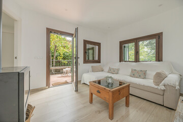 Composition of a classic living room with cherry wood furniture, a built-in fireplace with a carved wooden frame, and a decorative mirror