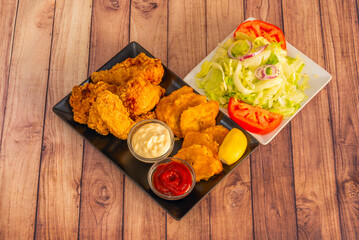 fried chicken with diced potatoes glazed with Chinese sweet and sour sauce and toasted sesame seeds.