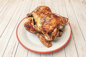 Roasted chicken leg with a honey, mustard, and soy marinade, served on creamy mashed potatoes and garnished with fresh parsley and peppercorns