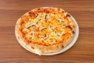 A wild mushroom pizza features varieties like porcini, shiitake, and portobello with confit garlic and fresh parsley on a truffle cream base.