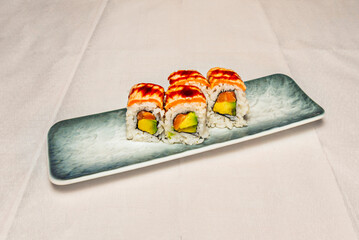 Spicy Tuna Uramaki with spicy tuna and avocado inside, mixed sesame seeds on the outside
