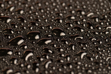 wet mirrored black glass in a large number of water droplets