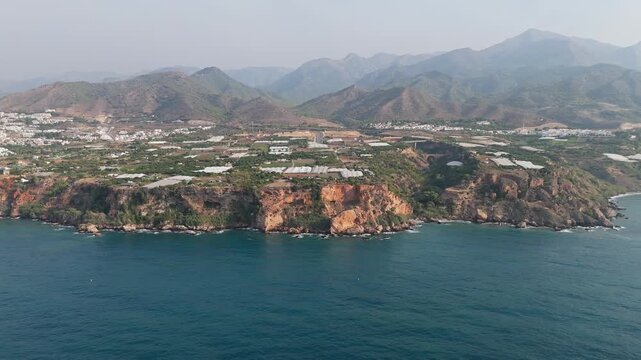 Aerial Drone POV of Nerja coastal town, which is a municipality on the Costa del Sol in the province of Malaga in the autonomous community of Andalusia in southern Spain.