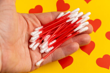red sticks with white cotton for hygienic procedures, sticks with cotton at the ends for personal hygiene