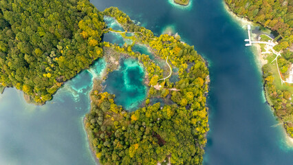 Aerial Drone View of Plitvice Lakes National Park in Croatia. Pristine turquoise waters, untouched wild forest, cascading waterfalls, and breathtaking natural beauty captured from above