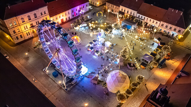 Aerial view of the vibrant Christmas market in Osijek's main square glows with festive lights and a towering Ferris wheel, Osijek, Osijek-Baranja County, Croatia.