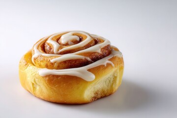 Single Cinnamon Roll with Icing Drizzle on a White Background for Dessert and Bakery Use