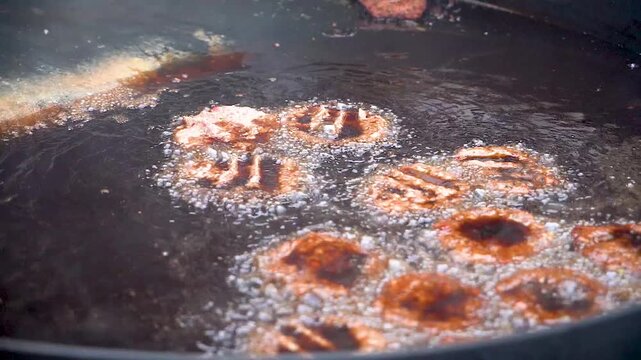 Slow motion shot of cooking of traditional Pakistani street food chappal kabab