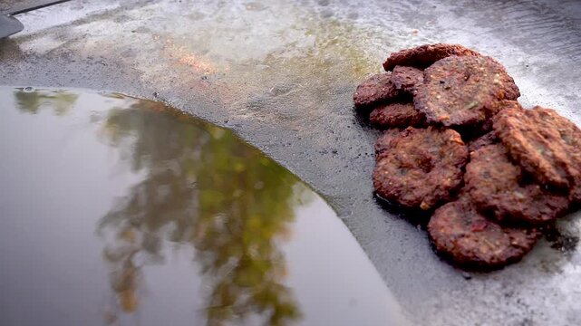 low motion shot of cooking of traditional Pakistani street food chappal kabab