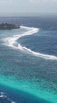 French Polynesia. Vertical Drone Shot of Coral Reef Barrier and Ocean Waves