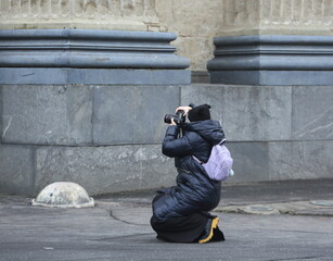 A female photographer takes a photo of an old building, Kazan Square, Saint Petersburg, Russia, November 17, 2025