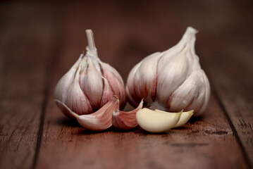 Garlic bulb and clove isolated. Garlic bulbs with cloves on wooden background