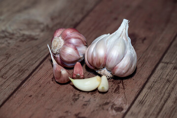 Garlic bulb and clove isolated. Garlic bulbs with cloves on wooden background