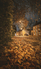 Autumn Night Scene: Golden Leaves and Historic Church Tower in Burton upon Trent Town Centre
