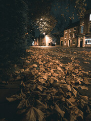 Autumn Night Scene: Golden Leaves and Historic Church Tower in Burton upon Trent Town Centre