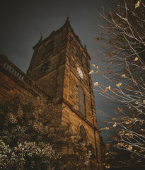 Autumn Night Scene: Golden Leaves and Historic Church Tower in Burton upon Trent Town Centre