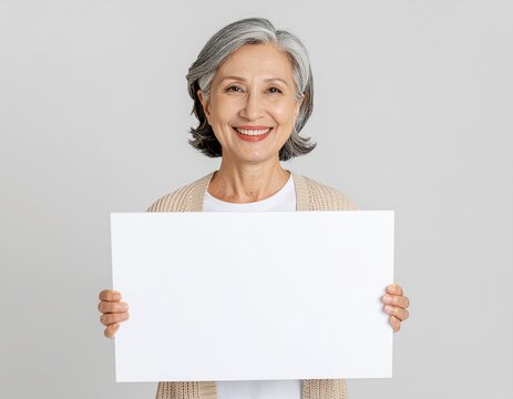 Happy Asian Grandma Smiling and Holding a Blank Board for Advertising