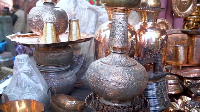 Slow-motion shot of Pakistani artist working on coppor
