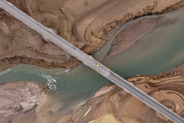 Aerial view of a bridge cutting across the river where the water flows swiftly, a solitary vehicle crossing it, Lisicići, Federation of Bosnia and Herzegovina, Bosnia and Herzegovina.