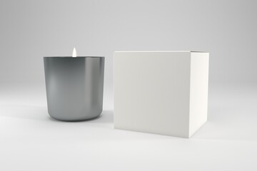 Elegant silver candle gently burning next to blank package box ready for your branding and product presentation