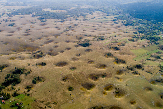Aerial view of a distinctive landscape dotted with numerous sinkholes, creating a mesmerizing pattern across the terrain, Kapljuh, Federation of Bosnia and Herzegovina, Bosnia and Herzegovina.