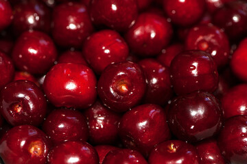background of large ripe cherries. A large collection of fresh red cherries. Close-up of juicy berries, harvest season. Good harvest in the garden. healthy food, lots of vitamins, diet, vegetarianism