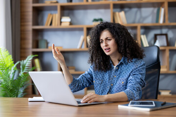 Frustrated woman experiencing technical difficulties with her laptop, feeling stressed and confused while working from home or in an office environment