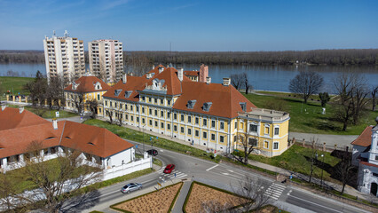 Aerial view of the Odescalchi Castle's baroque facade gleaming under the sun, juxtaposed against the tranquil Danube River, Ilok, Vukovar-Srijem County, Croatia.