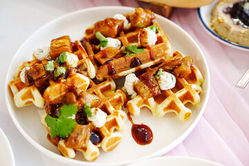 Delicious waffles topped with savory ingredients and sauce