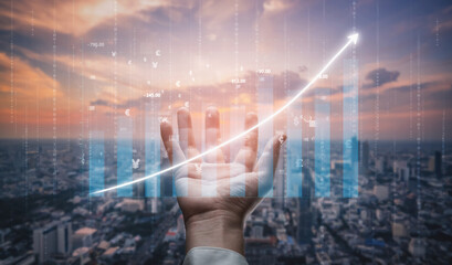 A hand reaches out symbolizing support and engagement in business growth, with a digital graph representing financial success against a city at sunset. Impute