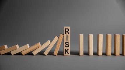 Wooden blocks demonstrate the concept of mitigating potential hazards with one piece standing firm