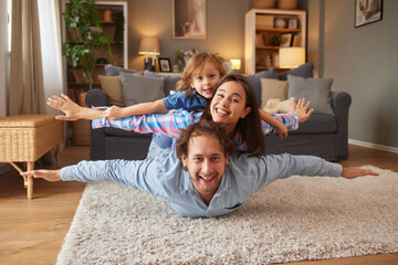 Family members engage in playful activities at home, laughing and enjoying precious moments...
